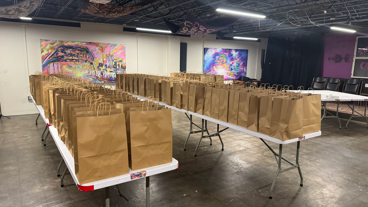 Tables full of brown grocery bags ready for distrubtion